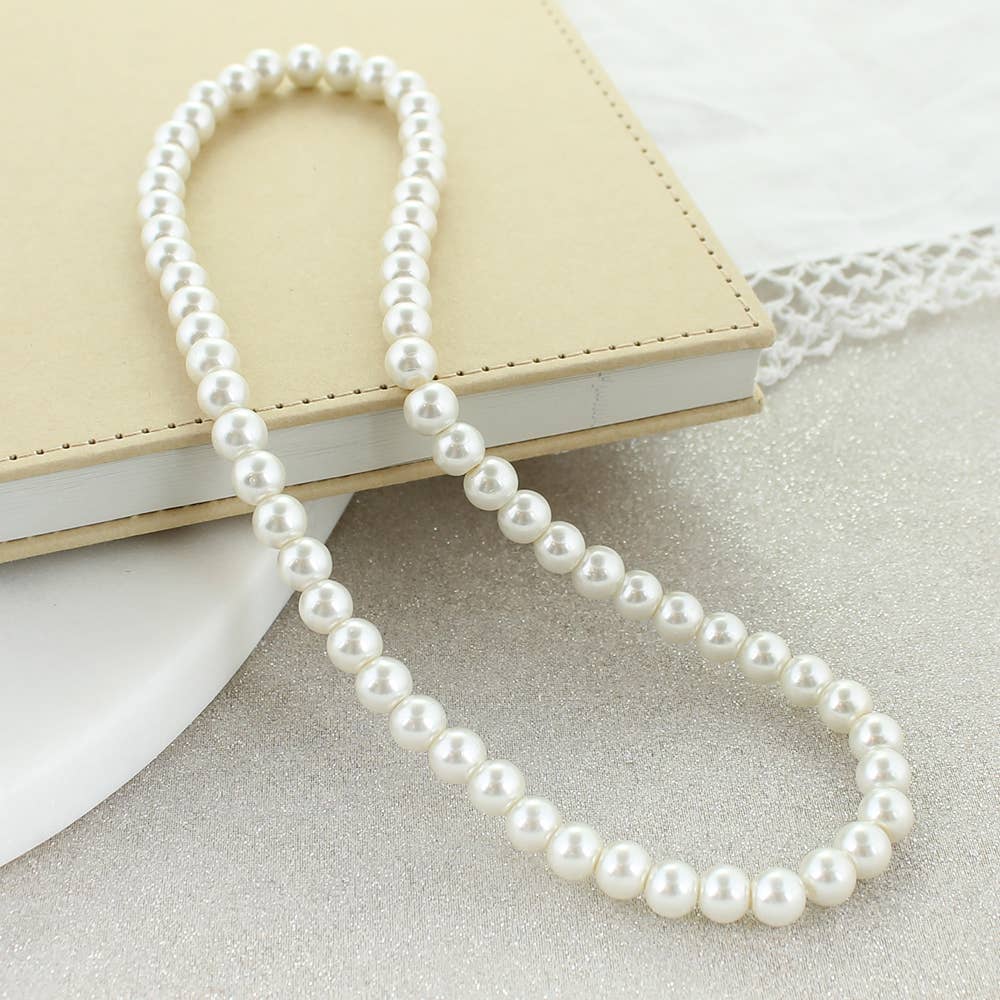 Classic imitation pearl stretch necklace displayed on a neutral background.