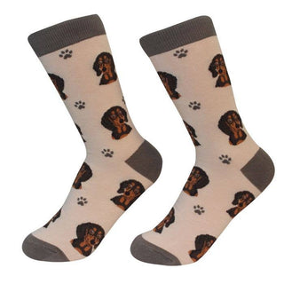 Unisex black socks featuring woven Dachshund faces and paw prints, crafted from high-quality cotton.