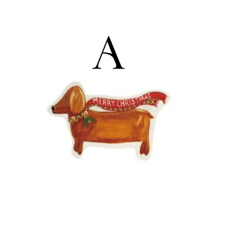 Multicolor stoneware dish shaped like a dog with a festive scarf and holiday saying.