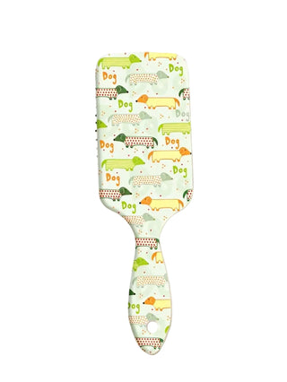 Hairbrush with a colorful dog pattern on a light surface