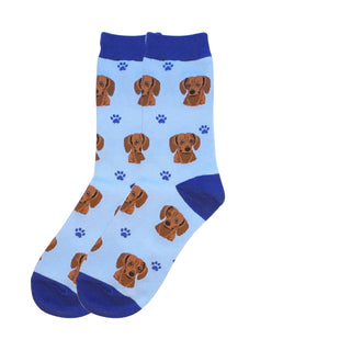 Pair of light blue crew socks featuring red Dachshund faces and blue paw prints.