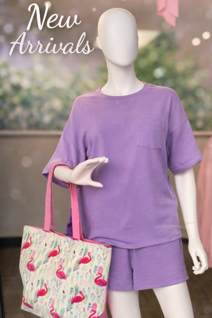 Mannequin wearing a purple outfit with a flamingo bag in a store setting, with 'New Arrivals' text.