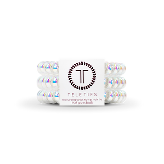 Set of white hair ties with iridescent sheen and 'Teleties' branding on a white background