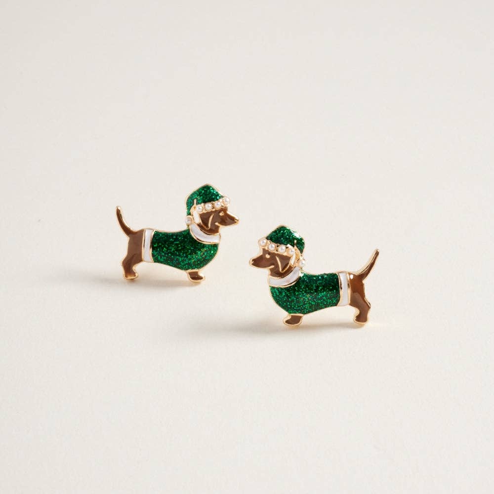 Glittery green dachshund-shaped Christmas earrings with pearl accents displayed on a neutral background.