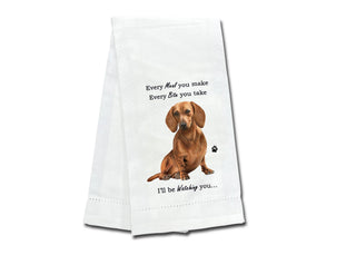 White kitchen towel with a printed red dachshund and text design.