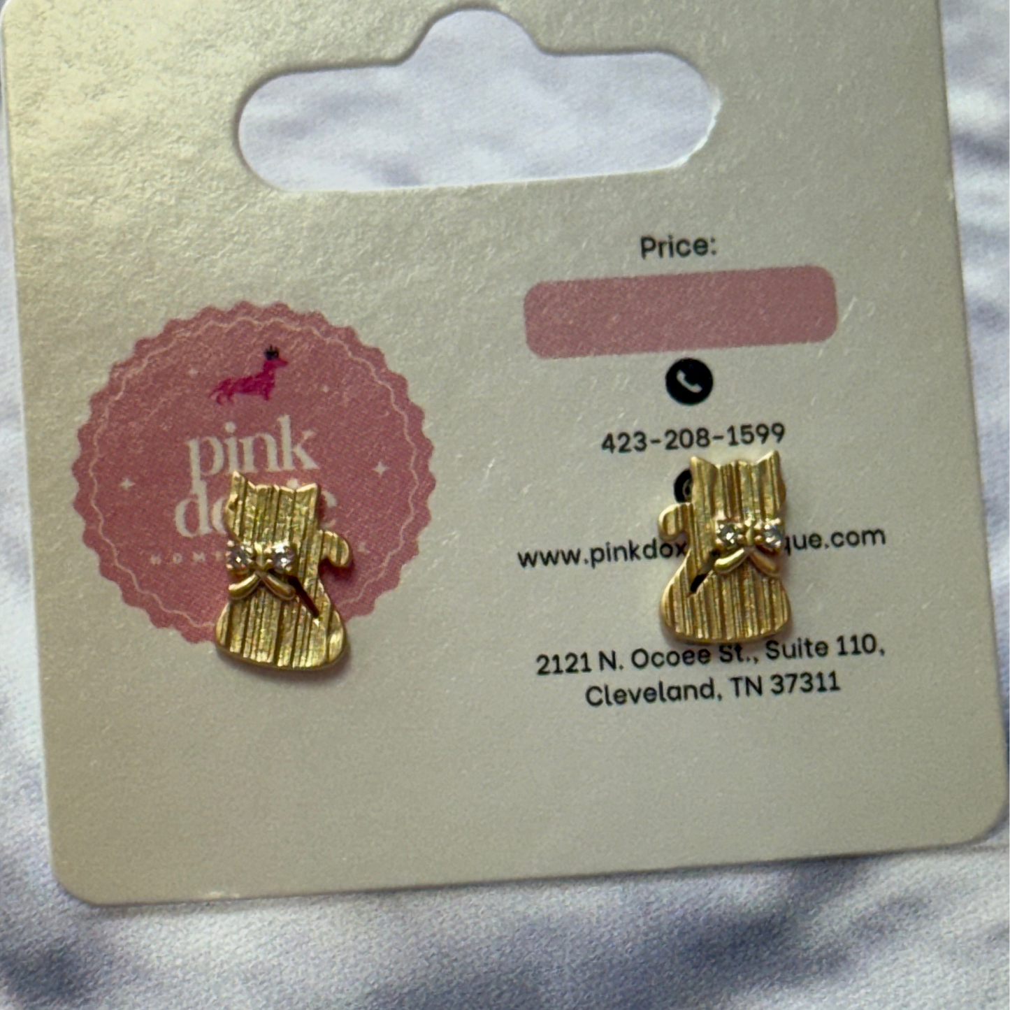 Brushed Gold cat-shaped earrings on a Pink Doxie branded card with contact information.