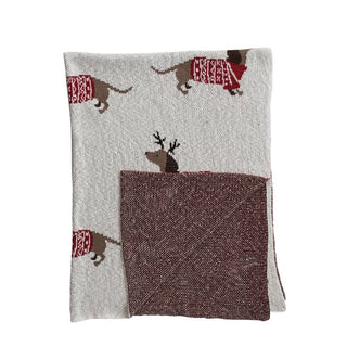 Cotton knit throw with dachshunds in red sweaters and antlers on a natural base.