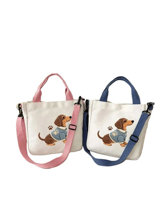 Two tote bags with dog illustrations on a light surface.