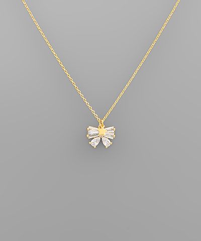 Gold-dipped necklace with baguette crystal ribbon bow pendant, photographed for The Pink Doxie Boutique.