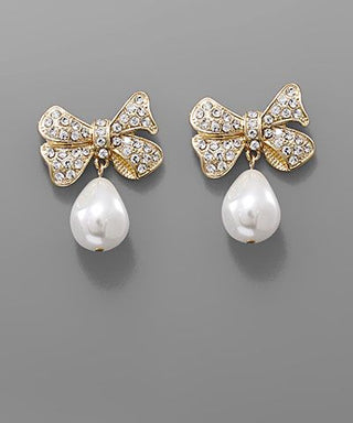 Teardrop pearl bow earrings with crystal accents in gold and silver tones displayed on a neutral background from The Pink Doxie Boutique.