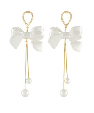 White pearl bow long tail earrings with crystal accents and dangling faux pearl drops from The Pink Doxie Boutique.