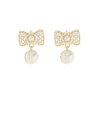 Gold-tone ribbon drop earrings with crystal details and a faux pearl accent displayed on a white background from The Pink Doxie Boutique.