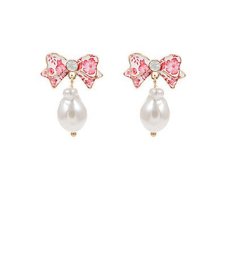 Floral printed enamel bow earrings with faux pearl dangle and titanium post displayed on a white background from The Pink Doxie Boutique.
