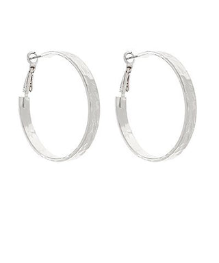 Silver-tone hammered hoop earrings with French post closure displayed on a white background from The Pink Doxie Boutique.