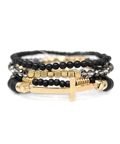Black and gold cross bracelet stack with layered beaded design