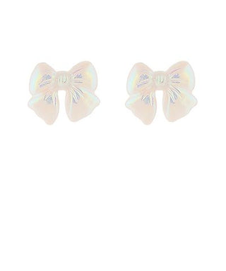 White acrylic bow stud earrings with a subtle iridescent sheen and gold-dipped accents on a white background from The Pink Doxie Boutique.