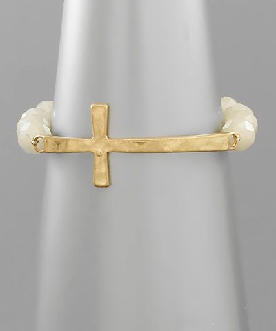 Gold sideways cross beaded bracelet on wrist