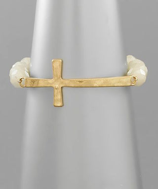 Gold sideways cross beaded bracelet on wrist