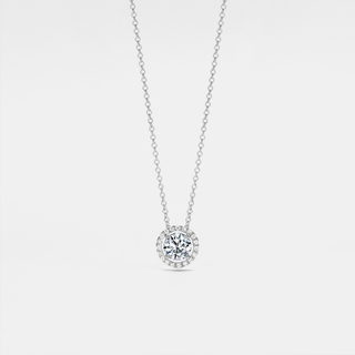 Four-prong moissanite halo pendant necklace in sterling silver with platinum plating — round D-color VVS1 stone sparkling on a delicate chain.