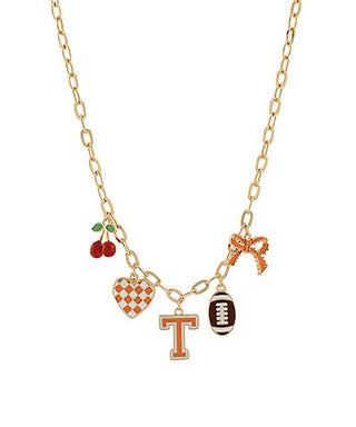 Gold-tone Tennessee gameday necklace with football and orange-inspired multi charms, photographed for The Pink Doxie Boutique.