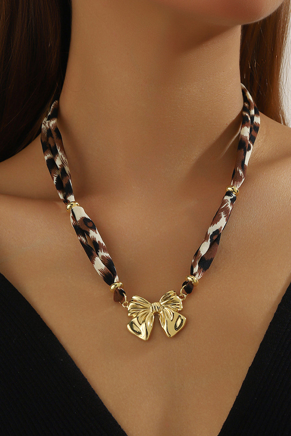 Gold bow charm leopard ribbon necklace with adjustable chain — elegant preppy accessory from The Pink Doxie Boutique.