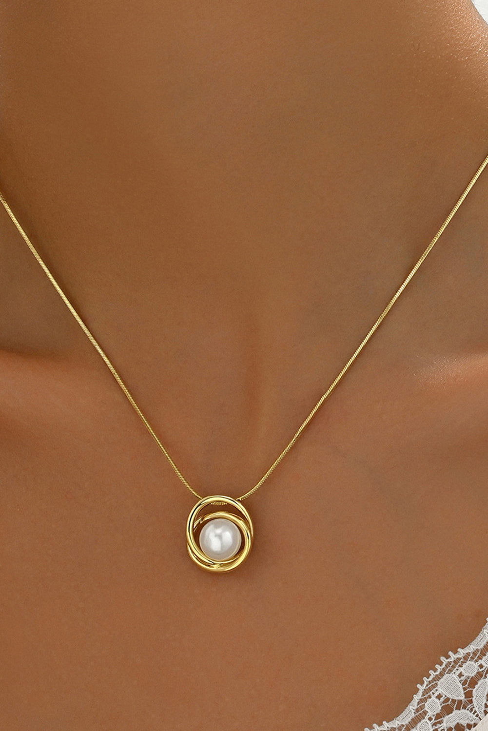 Woman wearing gold minimalist pearl pendant necklace — elegant classic jewelry piece from The Pink Doxie Boutique.