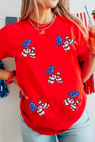 Red patriotic graphic tee with sequin balloon puppy designs in stars and stripes, styled with denim for Independence Day from The Pink Doxie Boutique.