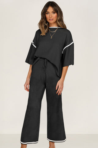 Black contrast trim knit sweater set with half sleeve top and drawstring pants styled with heels, photographed for The Pink Doxie Boutique.
