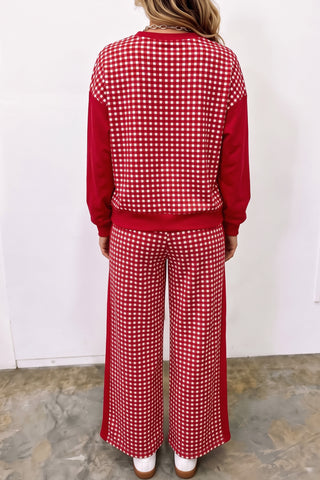 A woman wearing a two-piece matching set with a red and white gingham patchwork pullover with solid red sleeves and coordinating wide-leg pants with a drawstring waist and side pockets.