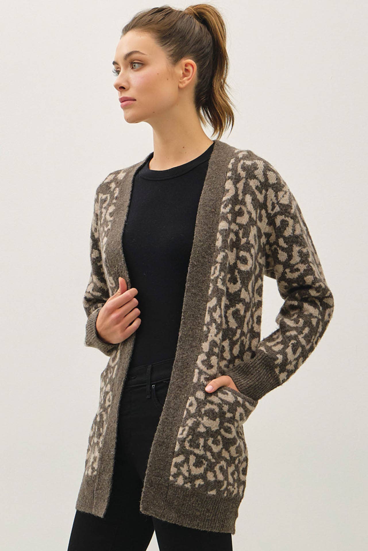 Brown and cream leopard knit cardigan, open front style.