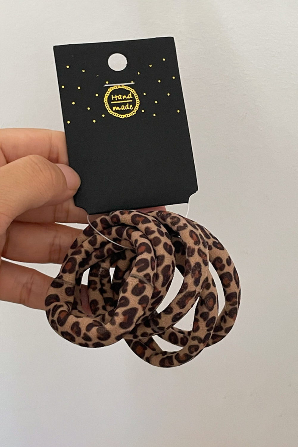 Set of 5 leopard print elastic hair ties held on a black “handmade” card — trendy hair accessories from The Pink Doxie Boutique.