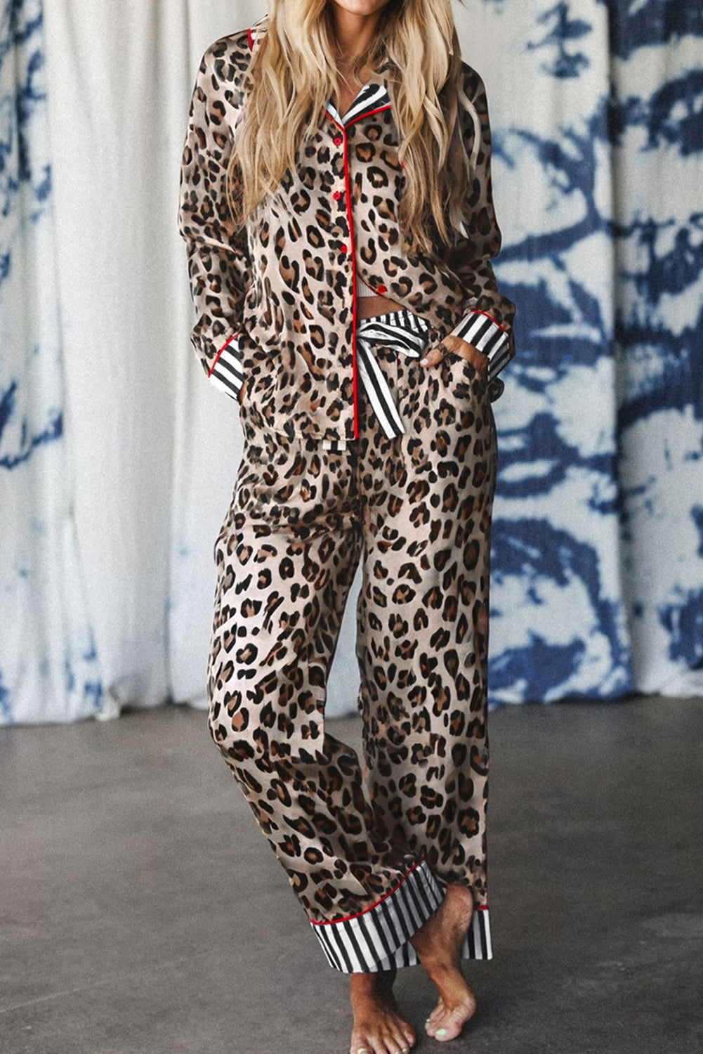 Woman wearing khaki leopard print pajama set with striped cuffs and red trim — cozy and chic lounge set from The Pink Doxie Boutique.