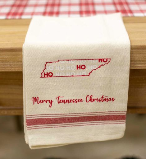 Cream hand towel with red Tennessee state outline reading “HO HO HO” and text “Merry Tennessee Christmas” embroidered in red.