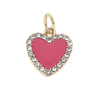Heart-shaped pendant with pink center and gold and crystal trim on a white background