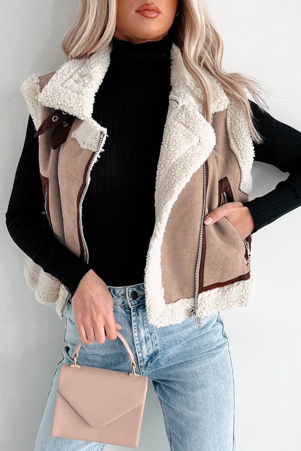 Woman wearing a dark khaki faux suede sherpa-lined vest with lapel collar and zip front – cozy boutique winter style from The Pink Doxie Boutique
