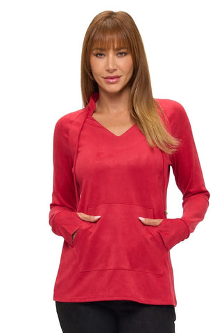 A woman wearing a cherry red long-sleeve pullover top with a v-neckline, raglan sleeves, cuffed wrists, and a front kangaroo pocket, styled with black pants.