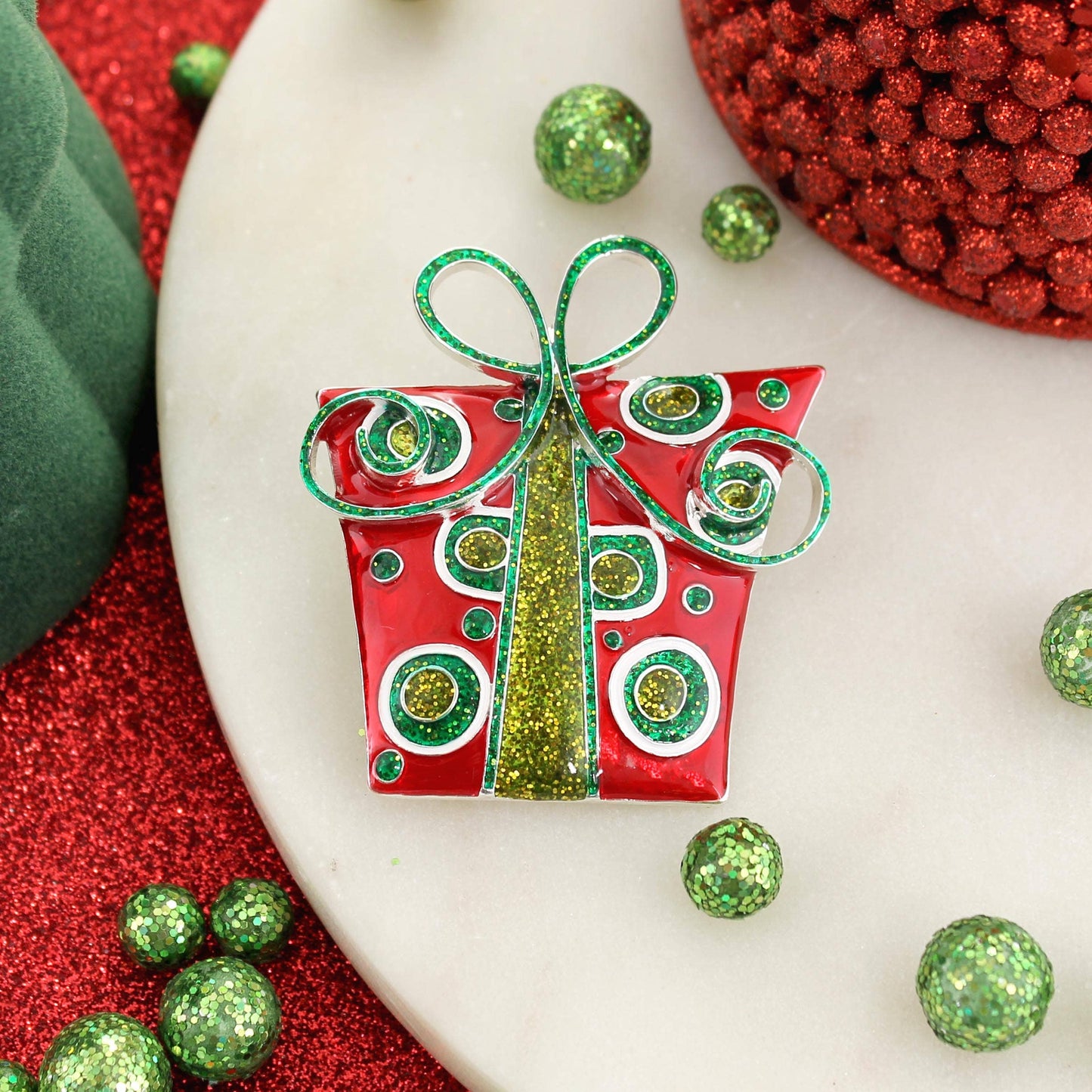 Add sparkle to your season with our Whimsical Christmas Package Pin Pendant! Glitter enamel and festive colors make it the perfect holiday accessory.