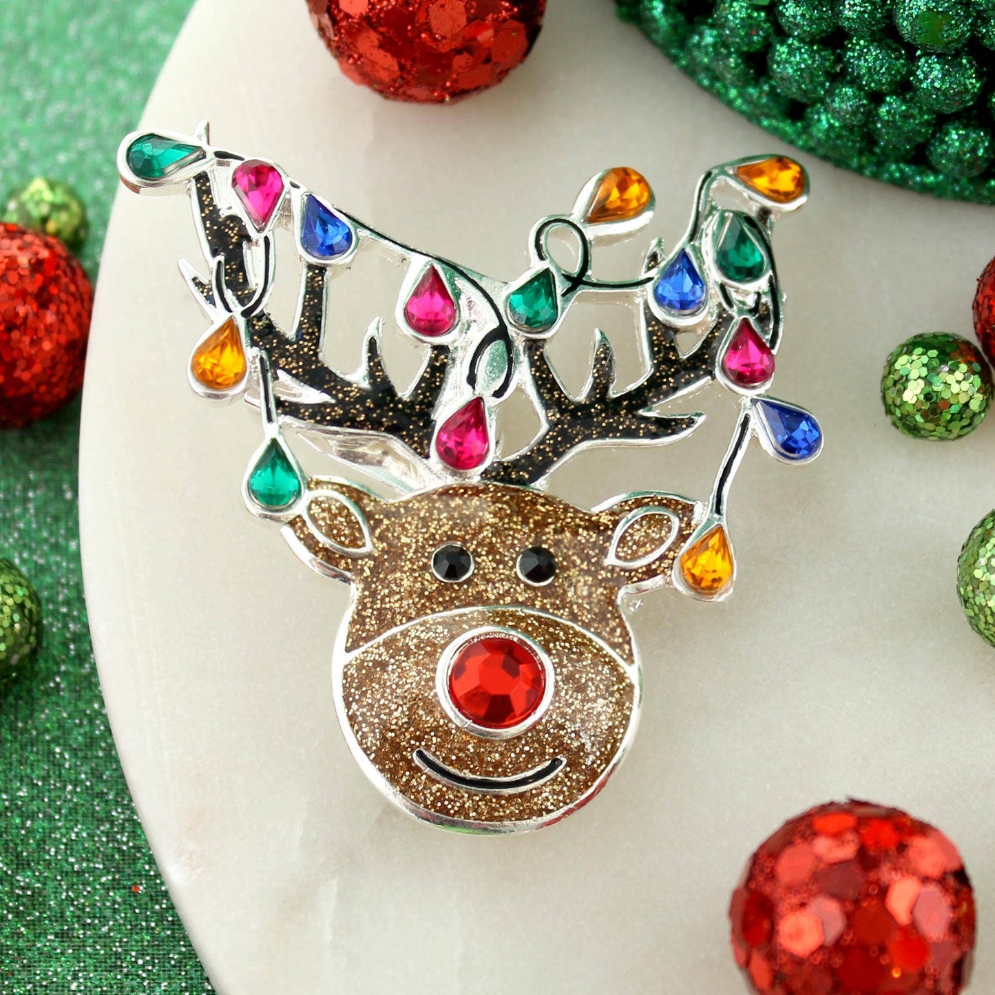 Silver-plated whimsical reindeer Christmas pin pendant with glitter enamel and colorful teardrop crystal lights — festive jewelry from The Pink Doxie.