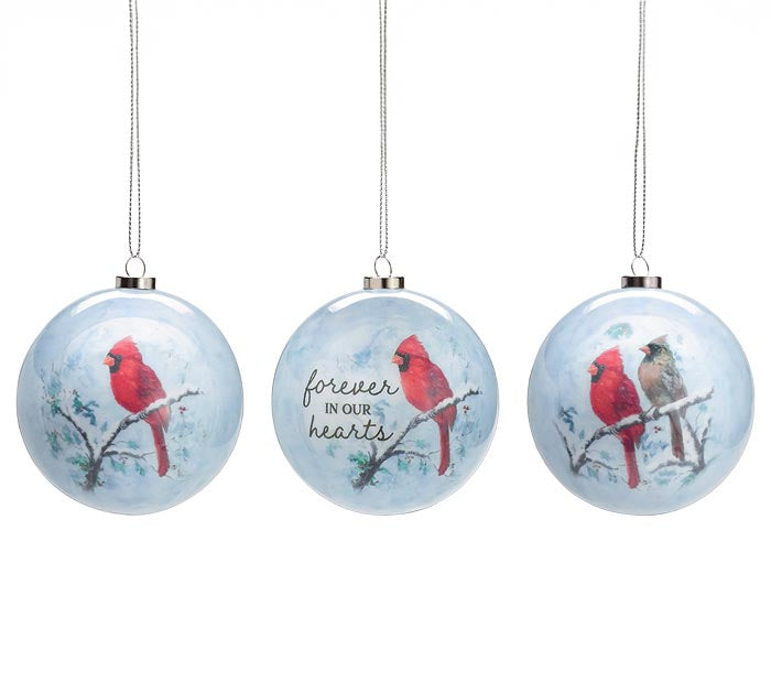 Three round paper mâché ornaments featuring red cardinals on snowy branches, one with the message “Forever in Our Hearts” — remembrance ornaments from The Pink Doxie.