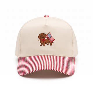 Beige cap with a dog and American flag design on a white background