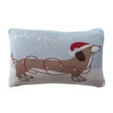 Lumbar pillow with a dachshund wearing a festive hat and lights, on a soft cotton knit fabric.